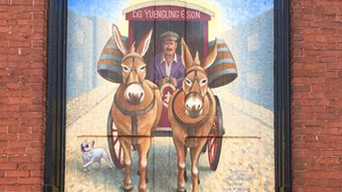 A close up of the completed mural showing a horse-drawn carriage