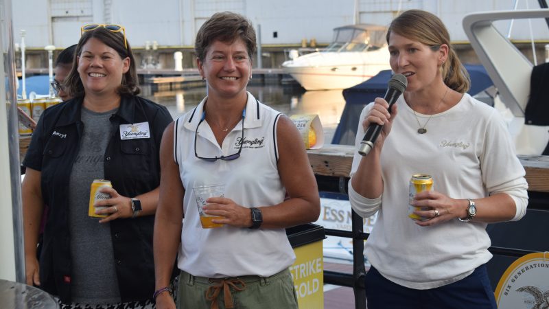 Sheryl, Jen and Wendy Yuengling holding Golden Pilsner and speaking to a crowd